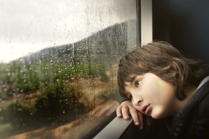 boy looking out train window